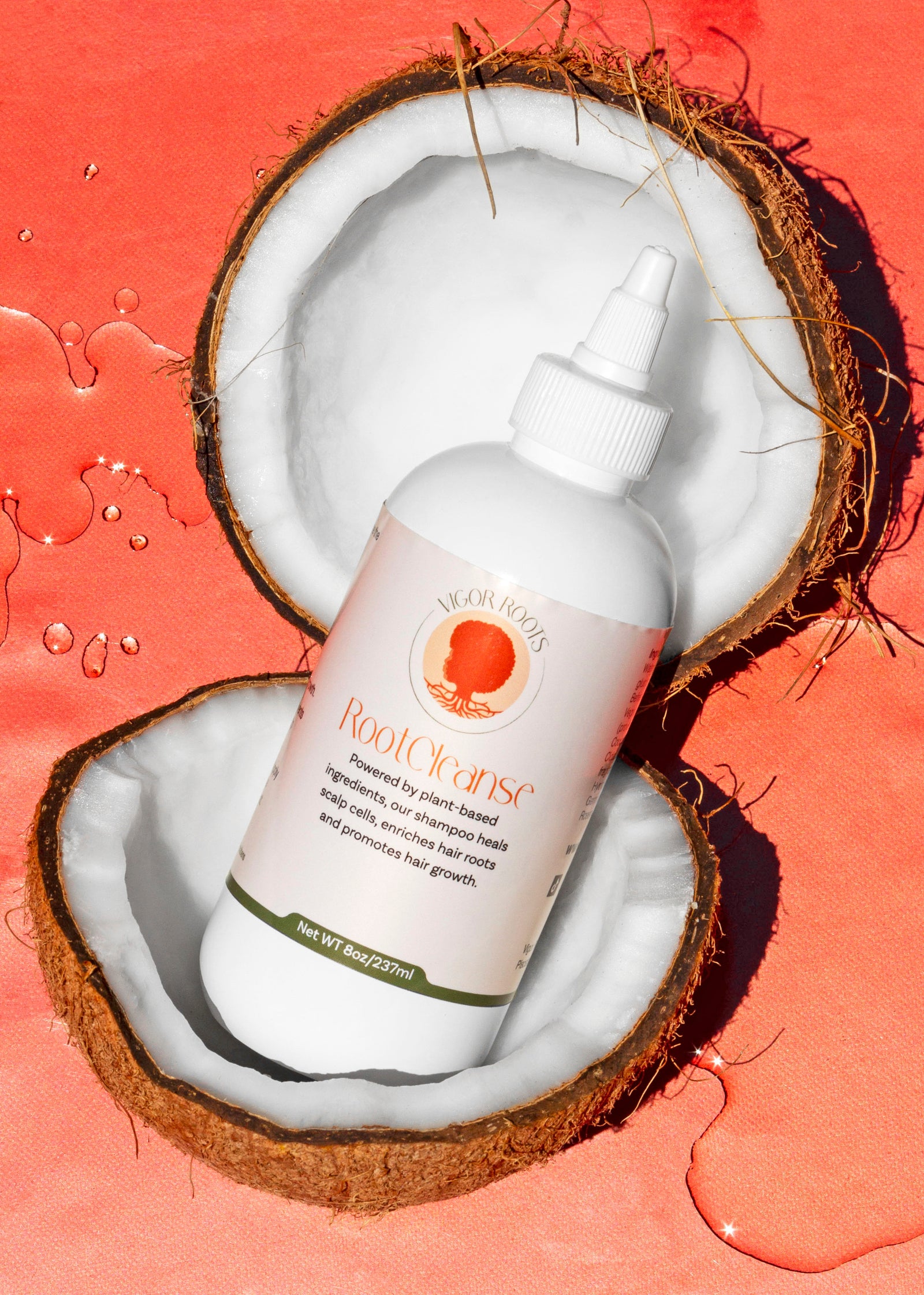 A ProductPhoto of RootCleanse: the best moisturizing shampoo for natural hair care. The bottle is posed inside of a coconut, one of the food-grade, natural ingredients included in the formula.